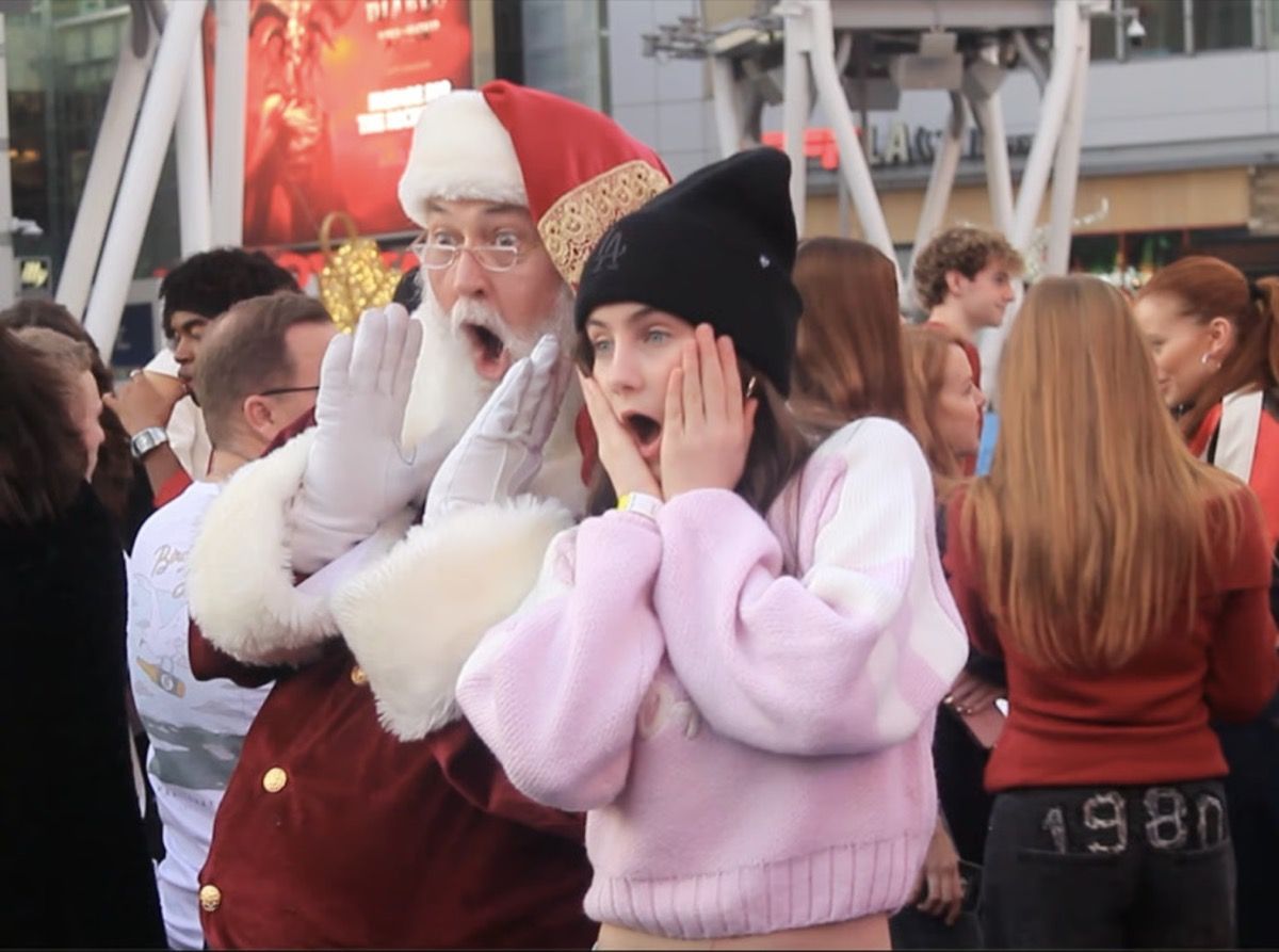 Santa Glenn and a young woman reacting with surprise in a crowd
