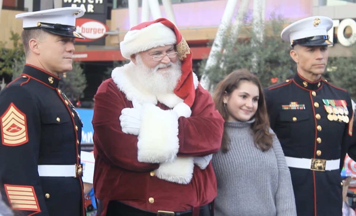 Santa Glenn standing with a young woman at an event