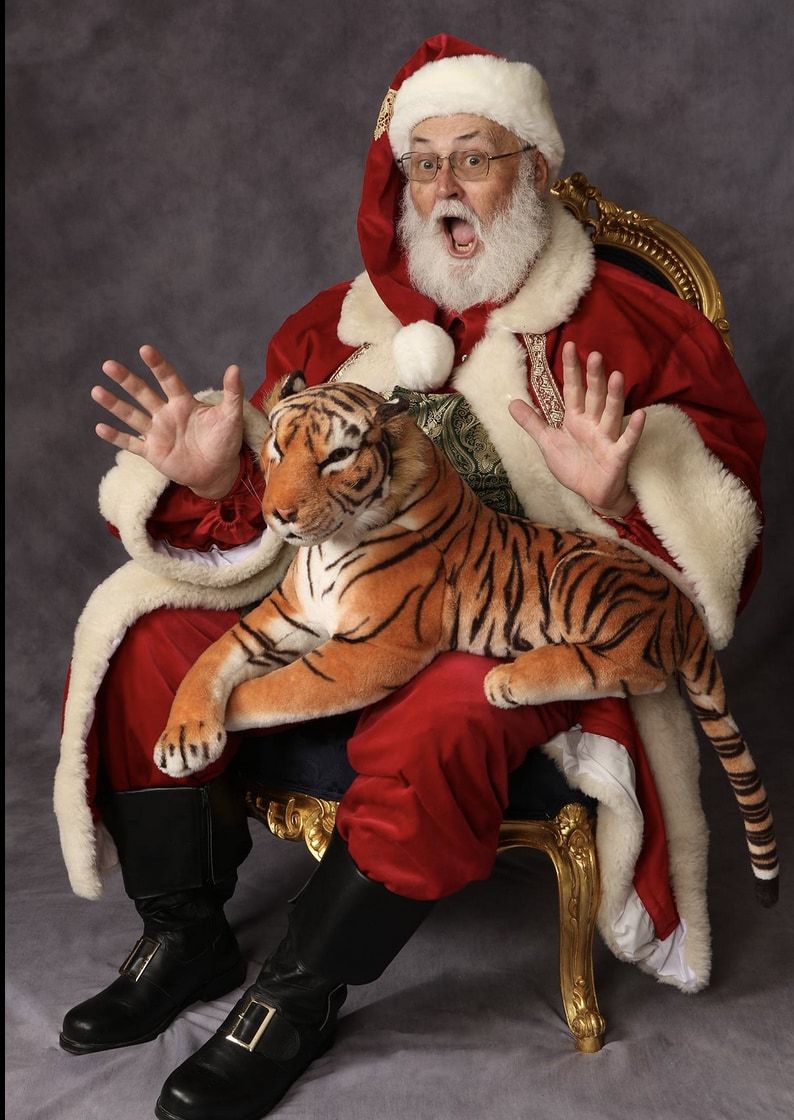Santa Glenn with a big toy tiger draped across his lap